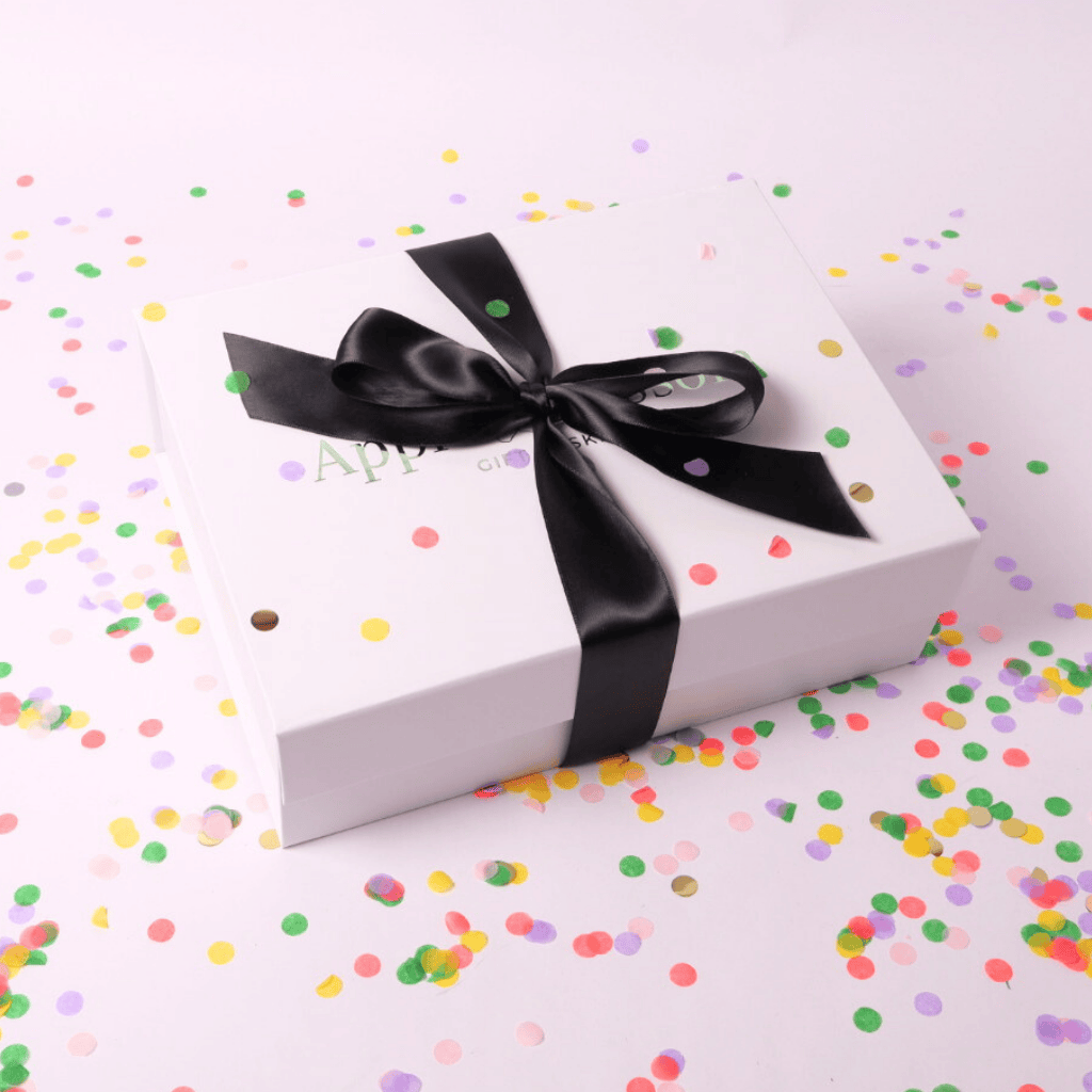 Thoughtfully curated celebration gift box with indulgent chocolates, gourmet popcorn, and a bubbly-inspired treat selection.