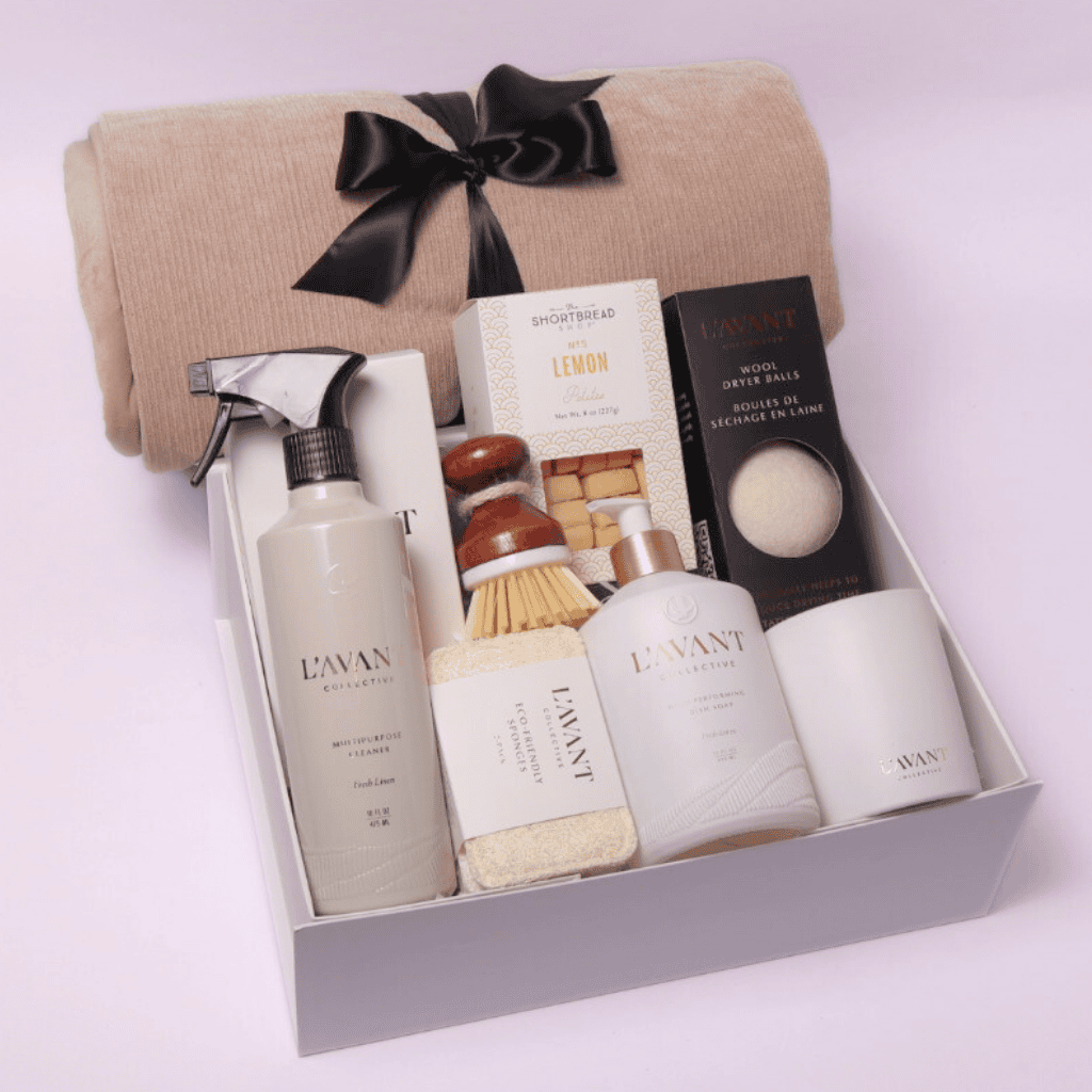 Elevate their new home experience with our luxury housewarming gift box, featuring plant-based cleaner, dish soap, a cozy throw, gourmet cookies, sponges, a scrub brush, and a fragrant candle, all elegantly presented in our signature white box.