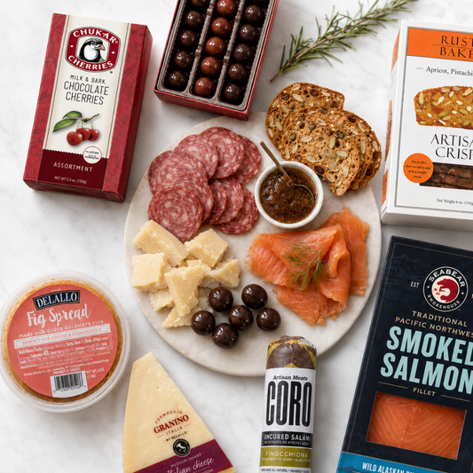 Gourmet charcuterie flat lay with smoked salmon, Coro salami, Granino cheese, Rustic Bakery artisan crisps, fig spread, and Chukar chocolate cherries.