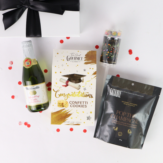 Grad Celebration Box with graduation confetti cookies, sparkling cider, Pop the Champagne popcorn, and confetti popper