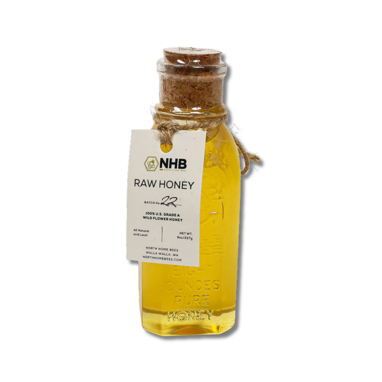 Bottle of north home bees walla walla raw honey with a label on a white background