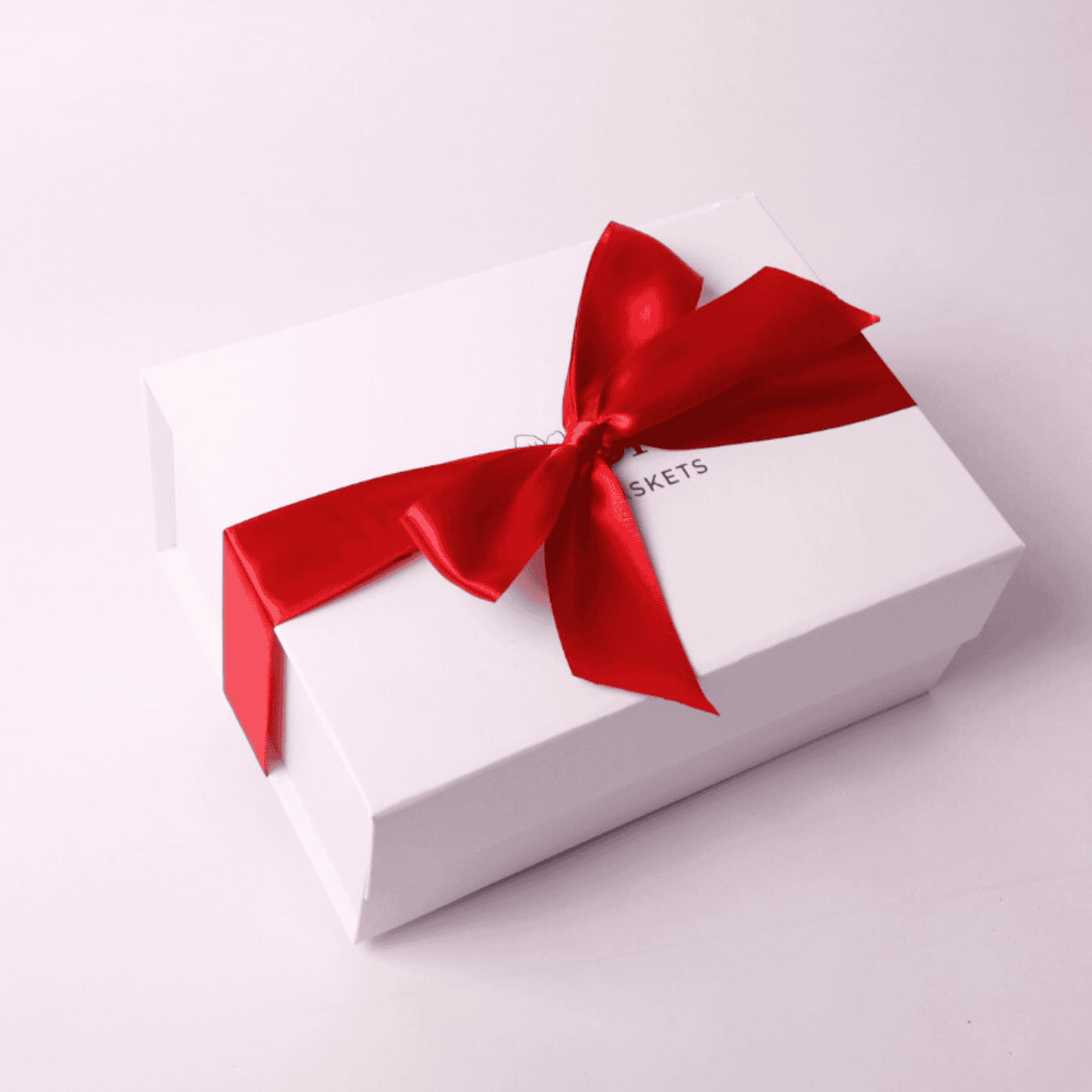A delicious PNW Bakery Box featuring Northwest Biscotti, Cougar Mountain cookies, and Lydia’s Cakes & Confections brownies—perfect for a thank you gift, foodie gift, or corporate client treat. All in a white gift box and red bow.
