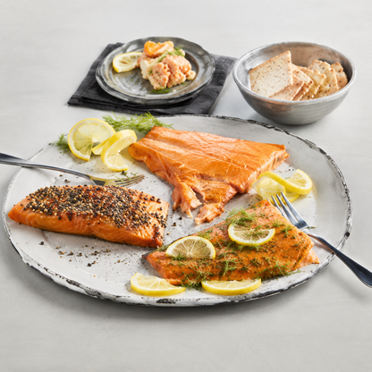 Plated salmon with lemon slices on a gray surface