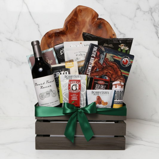 Best of the Northwest gift basket featuring artisan smoked salmon, Chocolate Cherries, gourmet nuts, handcrafted chocolate, popcorn, crackers, Florentina spritz, and other Pacific Northwest treats in a rustic wooden crate with a green satin bow.