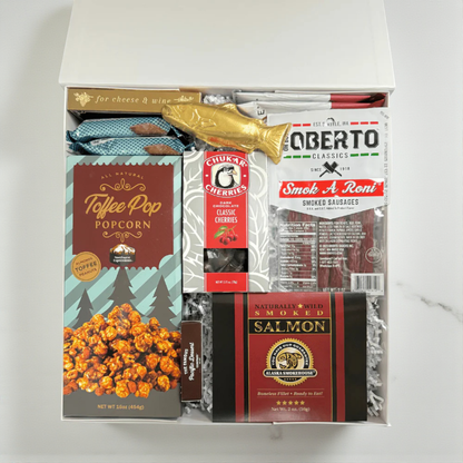 snack box filled with snacks made in WA.  The gift box includes: smoked salmon, pepperoni sticks, raosted nuts, crackers chocolate cherries and a solid chocolate salmon