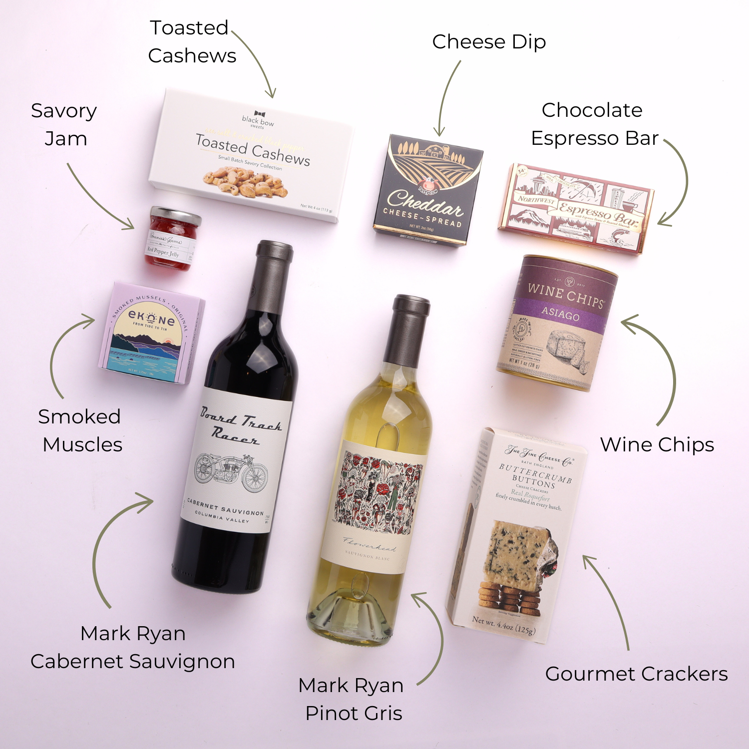 Flat lay of the products that come in the Washington wine and snack tray gift set.  Toasted cashews, cheese, dip, cabernet wine, pinot gris wine, wine chips, luxury crackers, smoked muscles, savory jam and chocolate espresso bar.