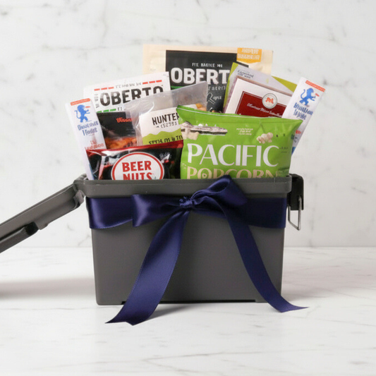 A thoughtfully curated men’s gift basket packed in a reusable ammo can, filled with beef jerky, popcorn, and savory snacks—great for Father’s Day, birthdays, or a thank-you gift for men.