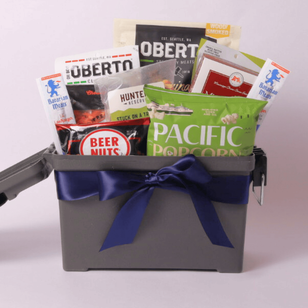 A thoughtfully curated men’s gift basket packed in a reusable ammo can, filled with beef jerky, popcorn, and savory snacks—great for Father’s Day, birthdays, or a thank-you gift for men.