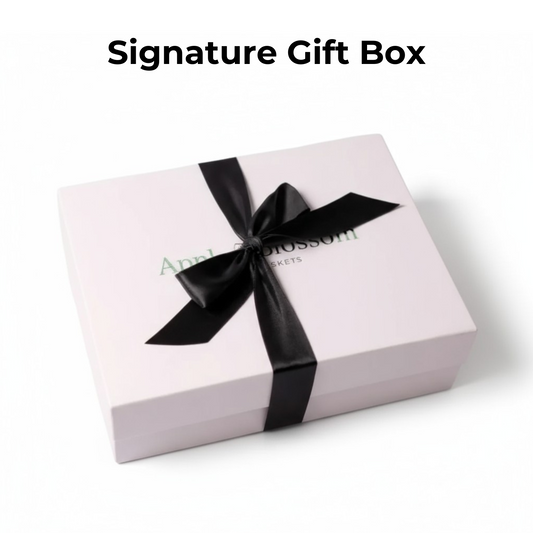White gift box with a black ribbon and 'Apple Blossom' branding on a white background