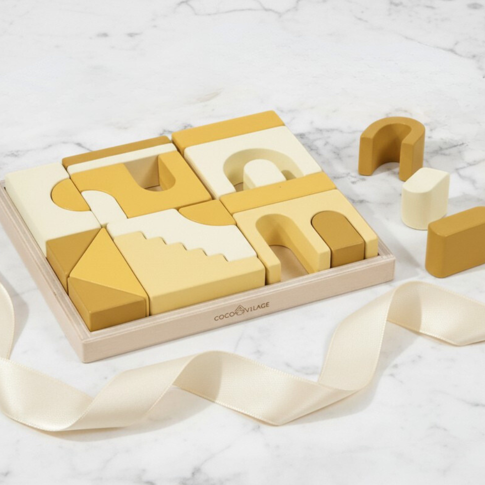 Set of wooden geometric blocks with a wooden box on a marble surface