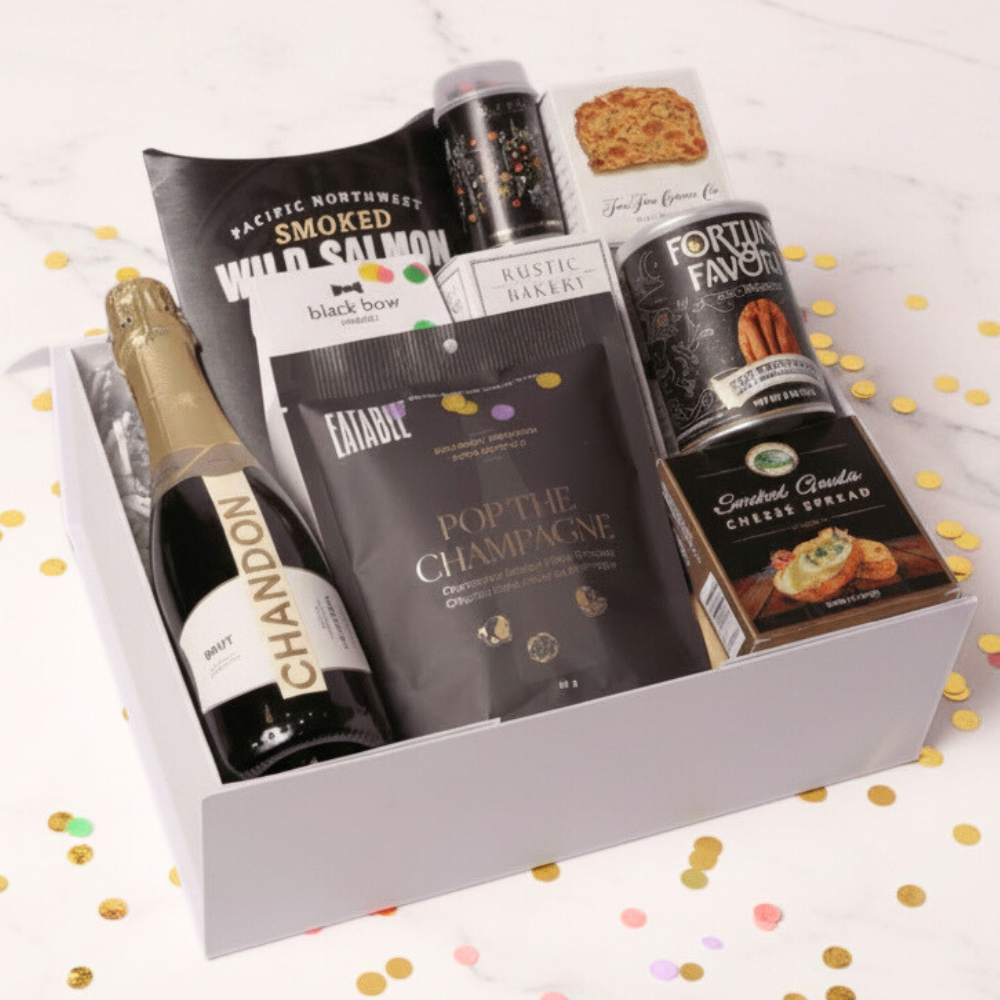 champagne gift box with snacks including cheese, crackers, smoked salmon and nuts