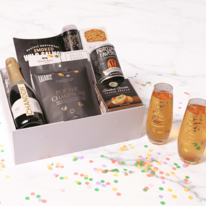 Raise a toast with our deluxe champagne and flute gift set! This elegant pairing of bubbly, artisanal snacks, and stylish glassware is perfect for engagements, New Year's, and milestone celebrations.