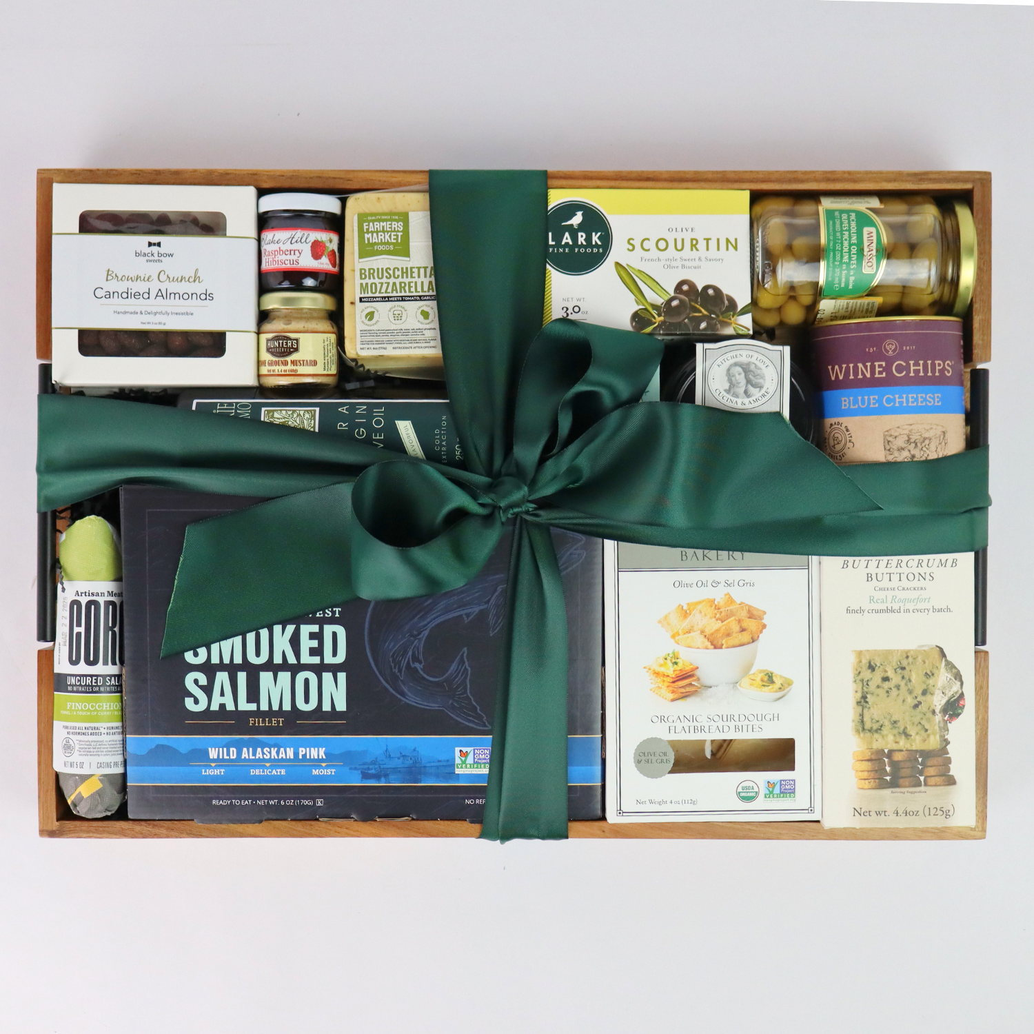 Holiday gift basket with Pacific Northwest smoked salmon, chocolates, and gourmet snacks tied with a festive green bow – perfect Christmas or corporate gift.