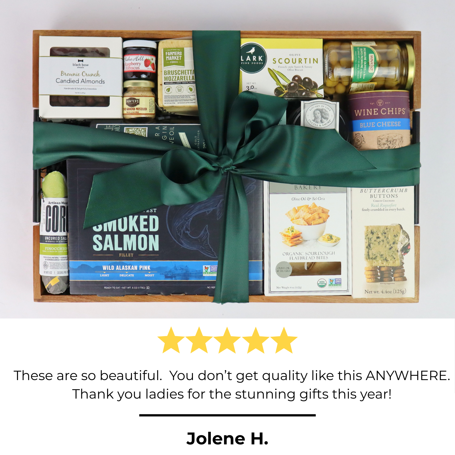 Holiday gourmet gift basket with green ribbon, smoked salmon, chocolates, and artisan snacks – perfect corporate holiday gift idea.