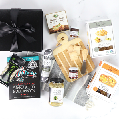 Assorted gourmet food items including smoked salmon, cheese, and bread on a white surface.