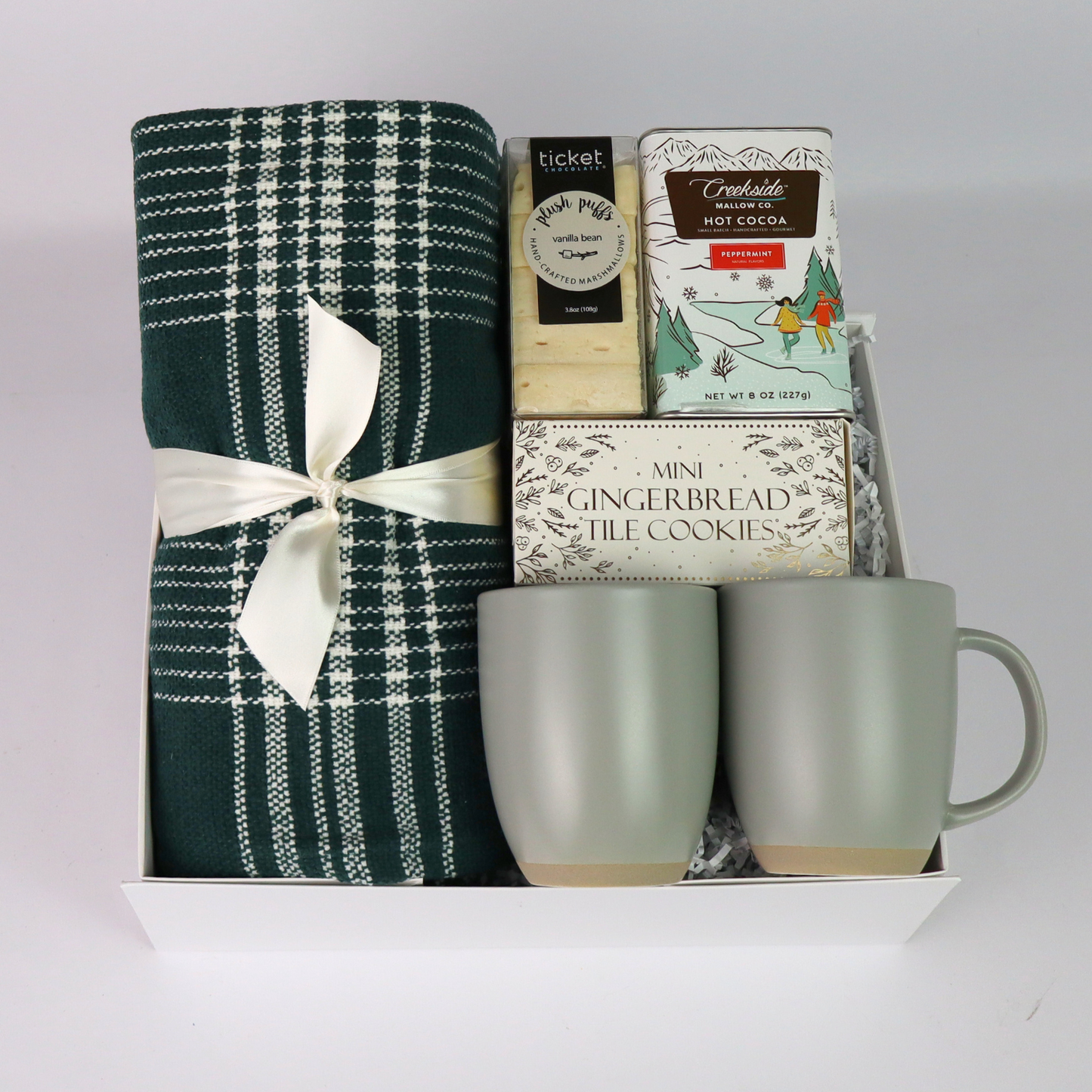 Cozy holiday gift box with a plaid throw, cocoa, and gourmet snacks, beautifully arranged in a luxury magnetic closure box. Ideal for family gifts or corporate holiday gifting.