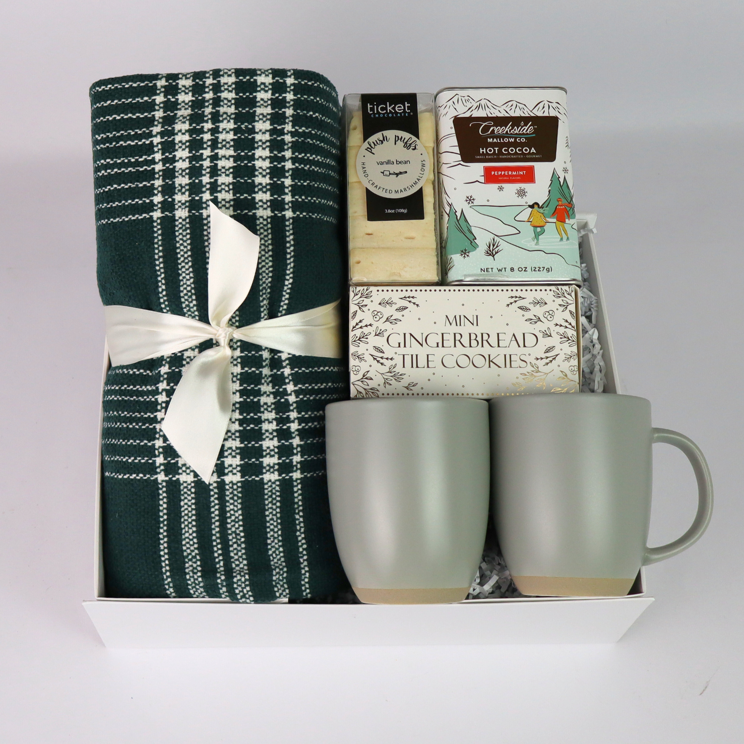 Cozy holiday gift box with a plaid throw, cocoa, and gourmet snacks, beautifully arranged in a luxury magnetic closure box. Ideal for family gifts or corporate holiday gifting.