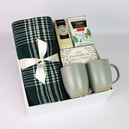 Luxurious Christmas gift box featuring a plaid throw, mugs, and festive treats, perfect for client gifts or as an elegant employee gift. Packaged in a soft-touch gift box with magnetic closure for a premium presentation.