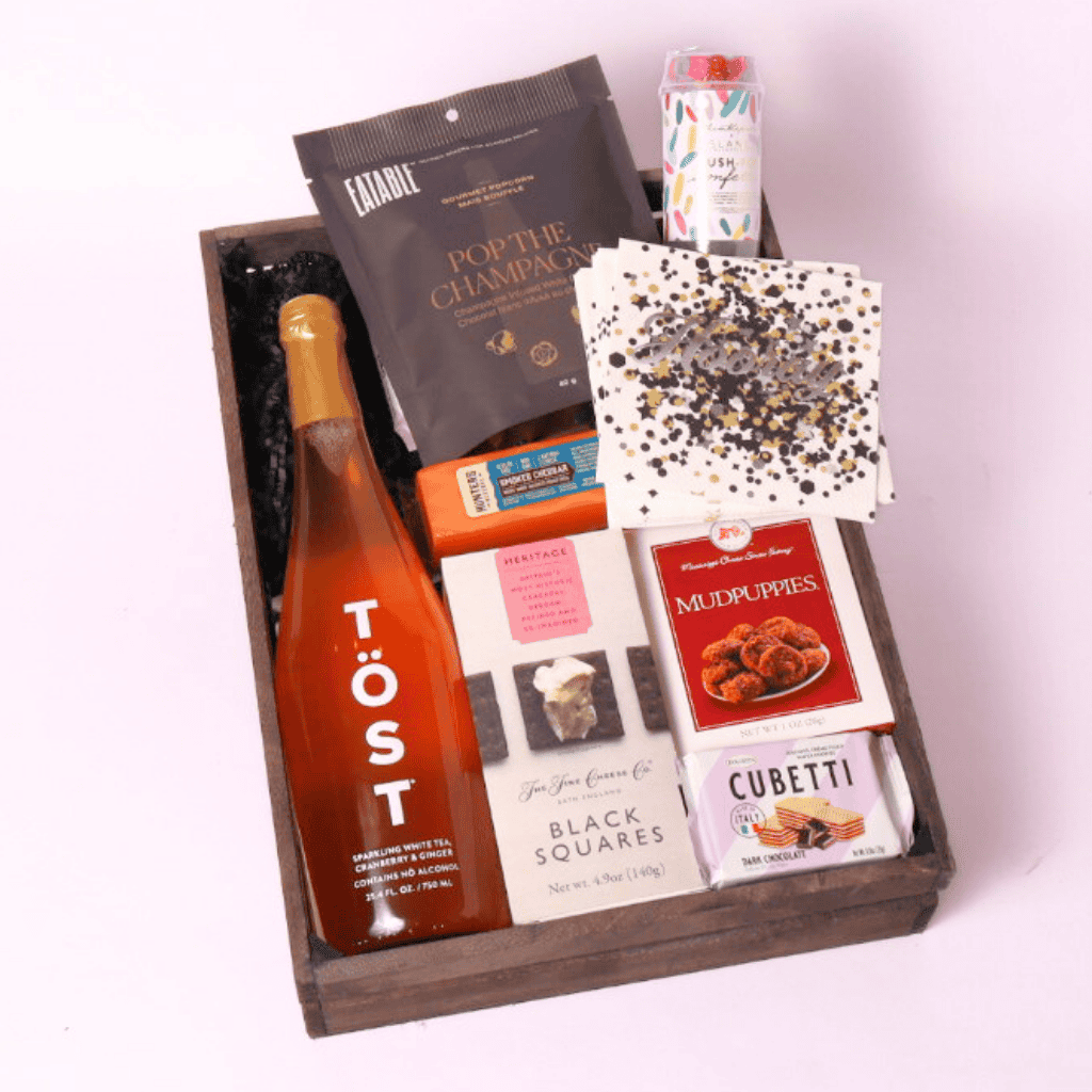 cue the confetti gift basket with  cookies, cheese, crackers, popcorn and party popper.  Made in WA by Apple Blossom Gift Baskets