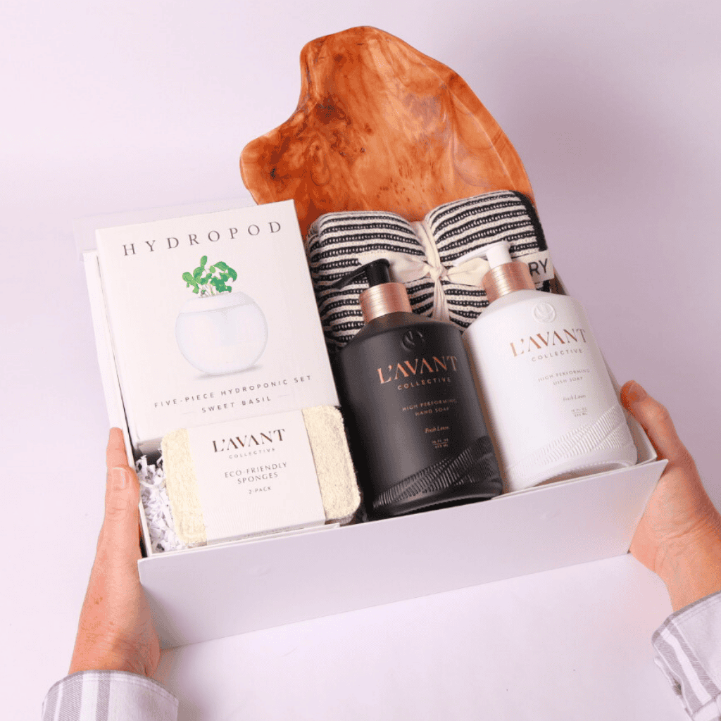Premium housewarming gift box with Seattle based L'AVANT Collective's luxurious home essentials, a hydroponic herb-growing kit, eco-friendly kitchen accessories, and a handcrafted acacia board—thoughtfully curated for new homeowners.