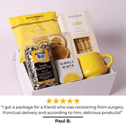 Image of the A Drop of Joy lemon-themed gift box with a glowing 5-star review, praising its beautiful presentation, delicious treats, and perfect fit for a care package, housewarming gift, or self-care gift box. A bright and cheerful way to send joy!