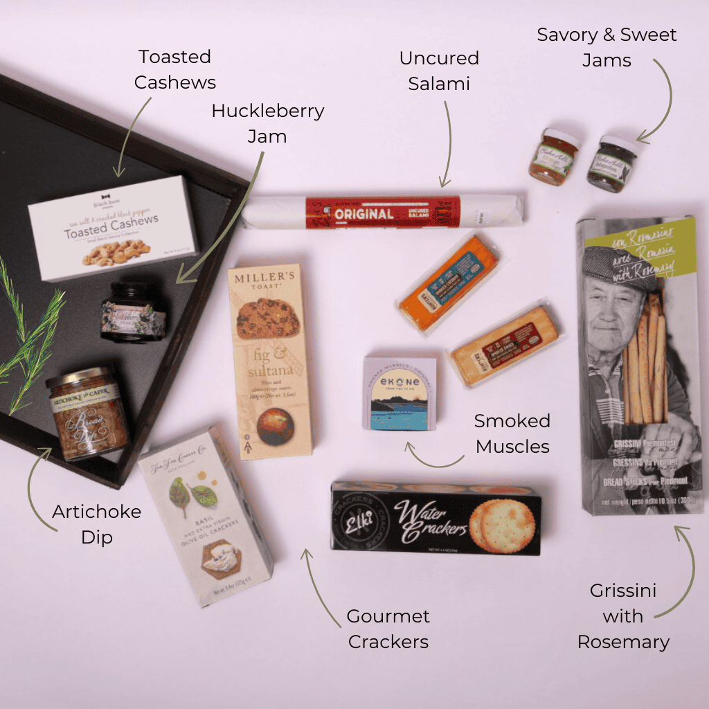 Locally sourced charcuterie snack gift set in an XL reusable wooden tray measuring 18" wide and 14" long, featuring Pacific Northwest treats like smoked muscles, artichoke dip, and savory jams—ideal for corporate events, holiday gifting, or client appreciation. Made in Seattle.