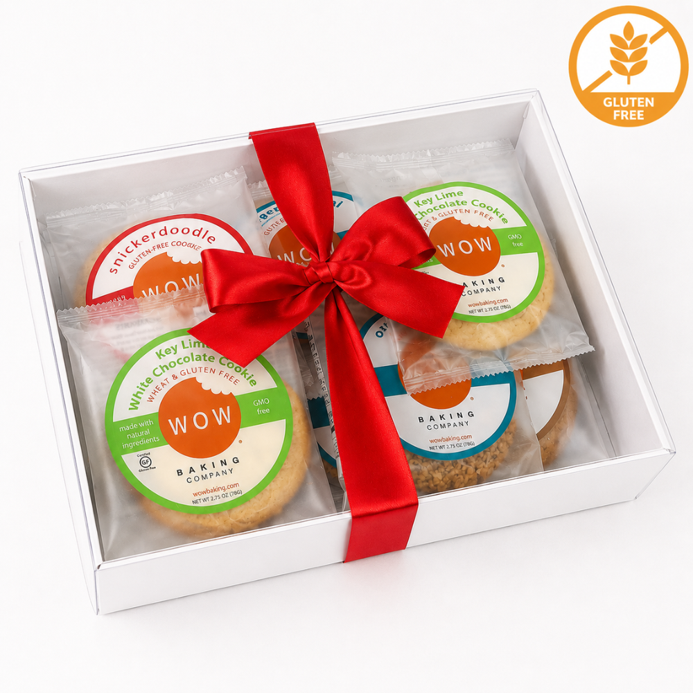A white gift box containing four round chocolate chip cookies, tied with a red ribbon, on a white background. A circular gluten-free badge appears in the top right corner.