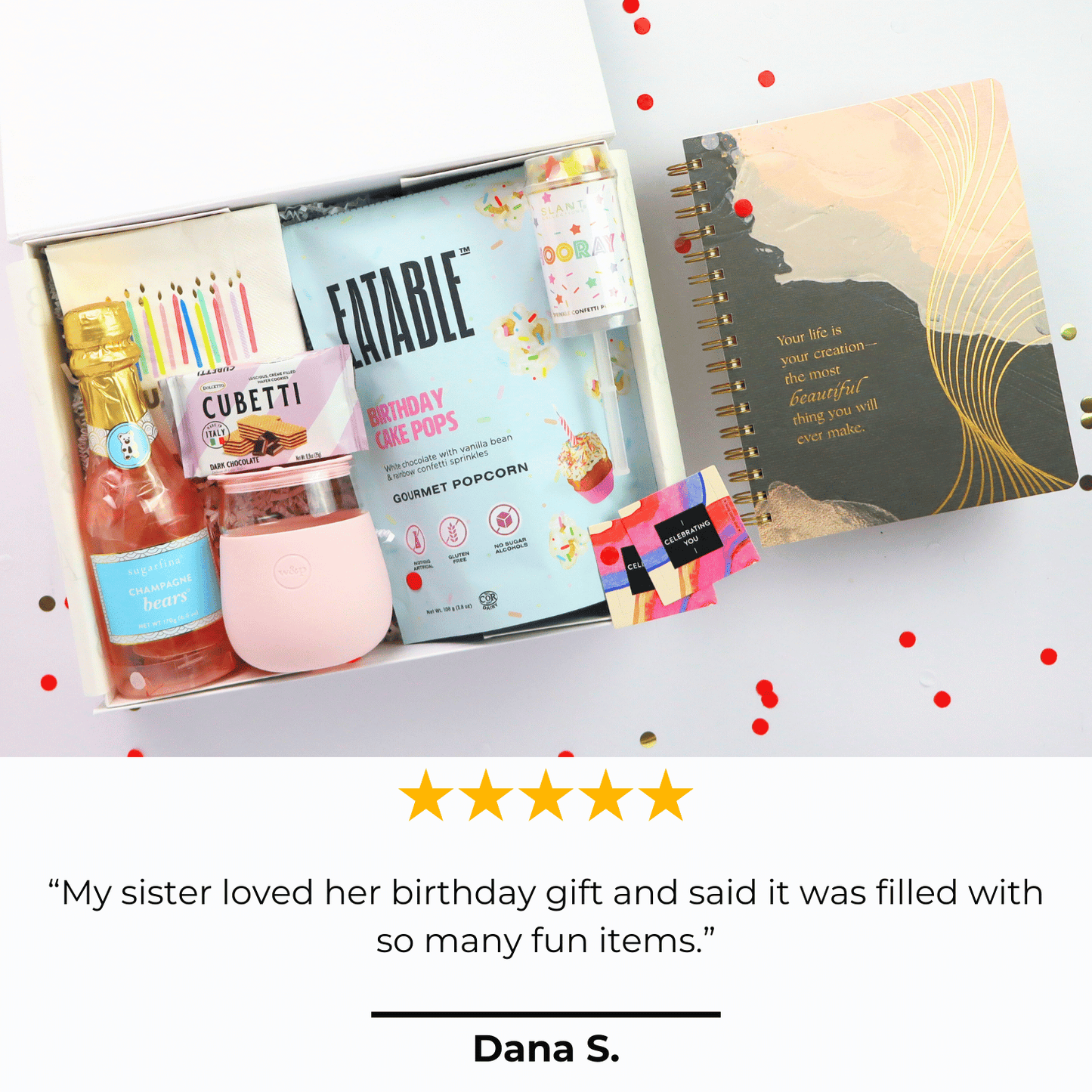 Luxury birthday gift box for her with birthday cake popcorn, rose lemonade, champagne gummy bears, a pink tumbler, and festive decor.