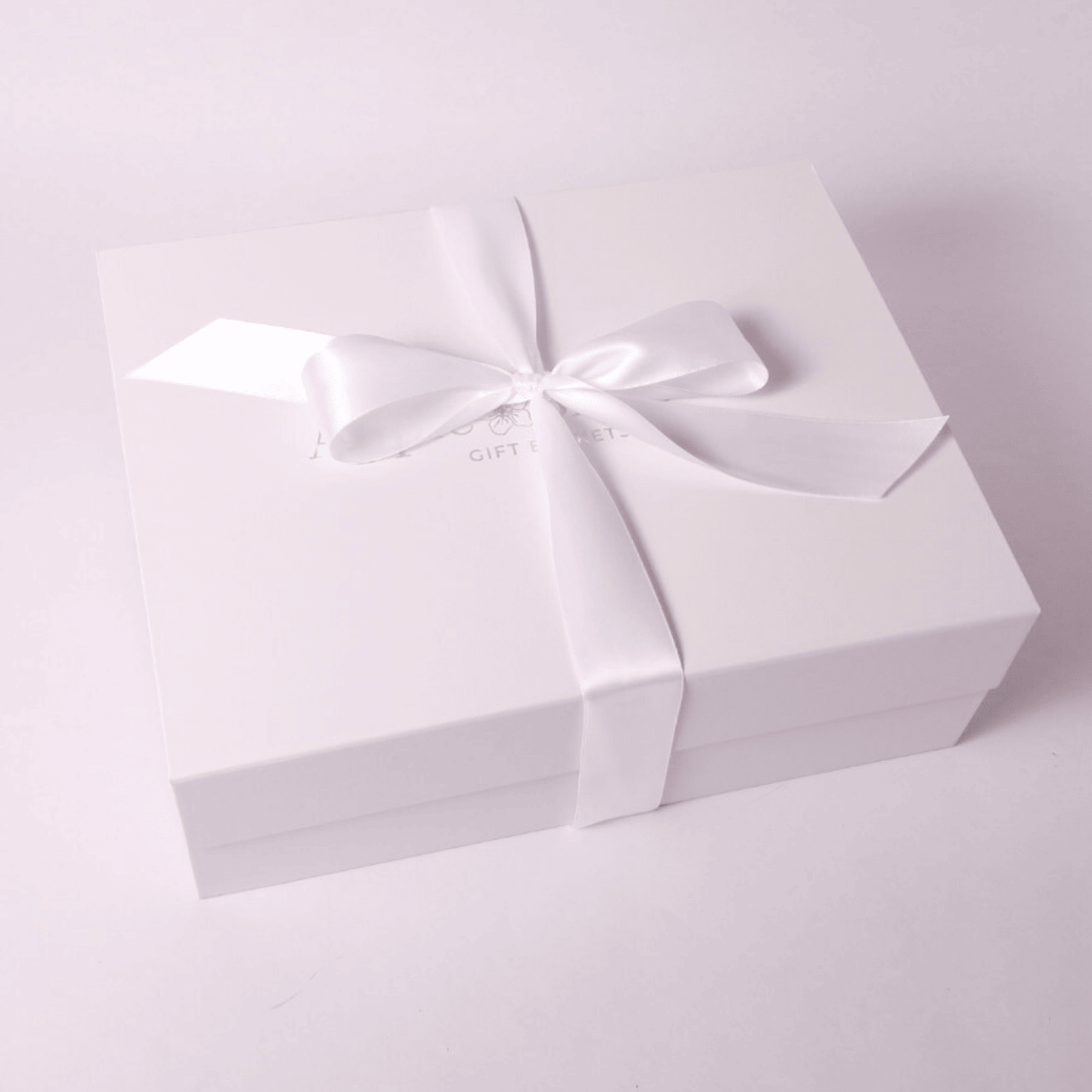 signature white soft touch luxury gift box with hand tied white satin bow made in Washington.