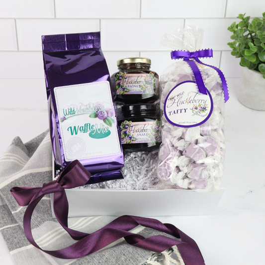 Wild huckleberry breakfast gift basket with jam, honey, waffle mix, and taffy in a white gift box