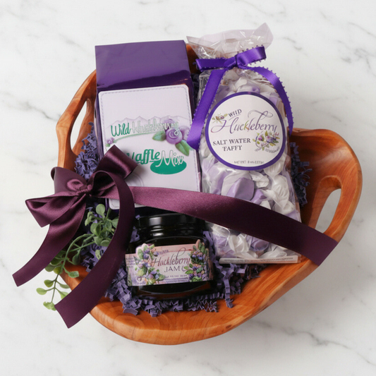 Handcrafted Washington Huckleberry Gift Basket – A beautifully arranged gift set featuring wild huckleberry jam, saltwater taffy, and waffle mix in a hand-carved, upcycled fir root wooden bowl. A unique gourmet gift!