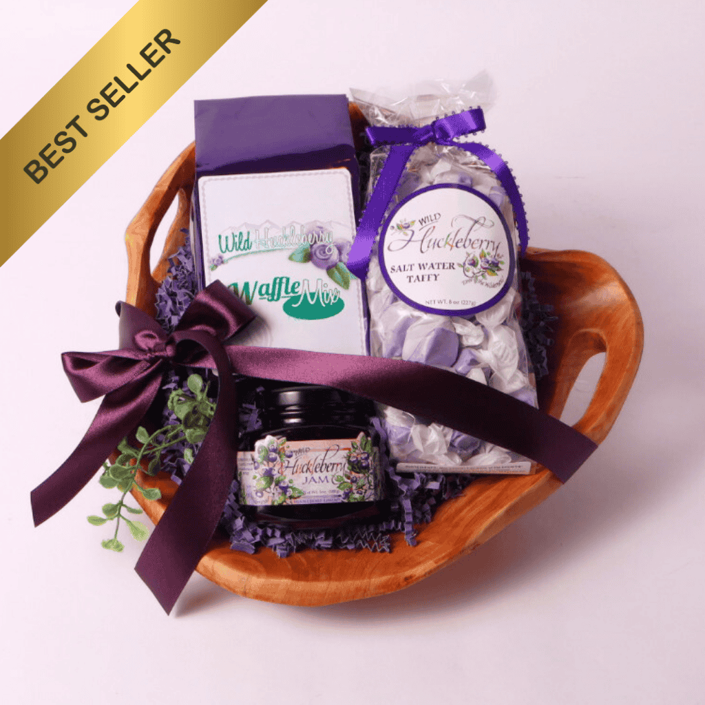 Handcrafted Washington Huckleberry Gift Basket – A beautifully arranged gift set featuring wild huckleberry jam, saltwater taffy, and waffle mix in a hand-carved, upcycled fir root wooden bowl. A unique gourmet gift!
