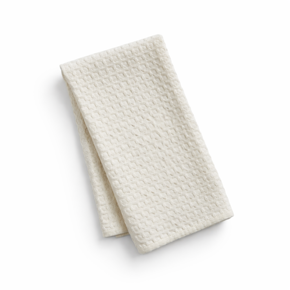 Folded textured white kitchen towel on a white background for housewarming gifts