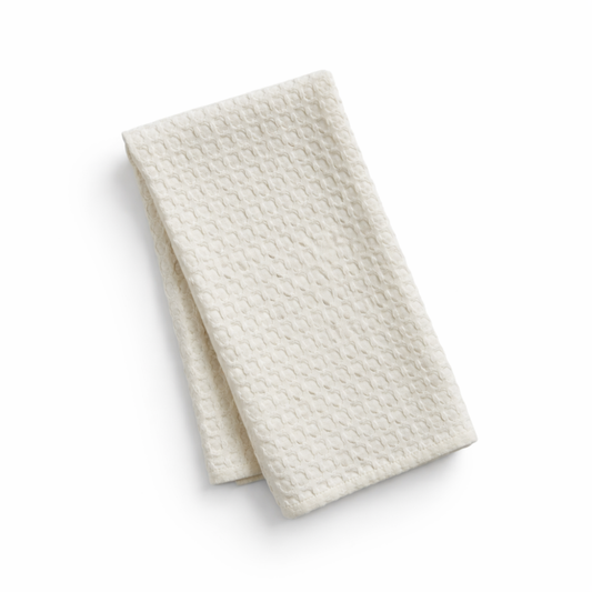 Folded textured white kitchen towel on a white background for housewarming gifts