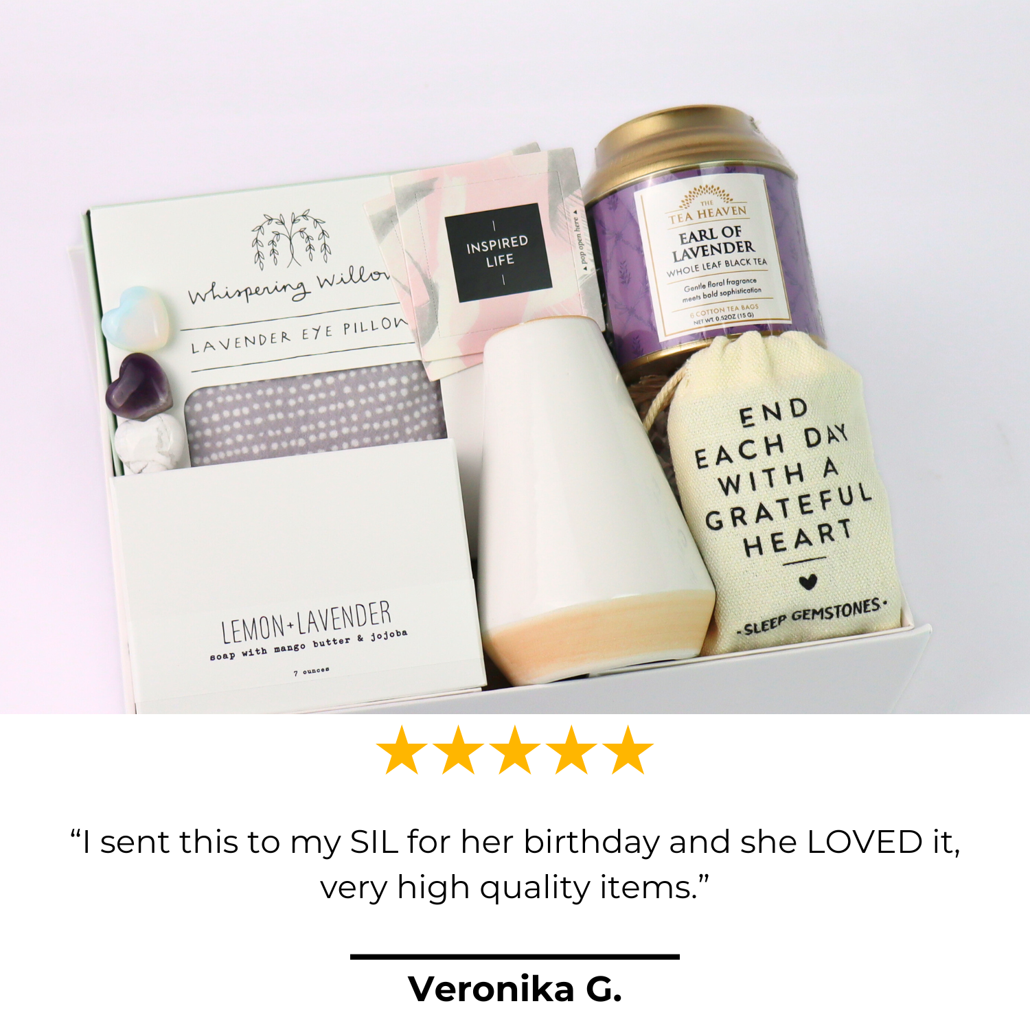 Gift set with lavender eye pillow, tea, and card on a white background.  Lavender Self-Care Gift Box with review card and product display, featuring tea, soap, and relaxation gifts