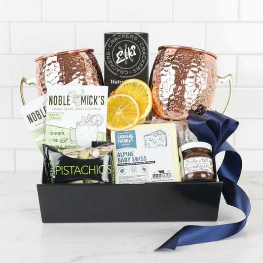 moscow mule Gift basket with copper mugs, snacks, and moscow mule mix on a white background