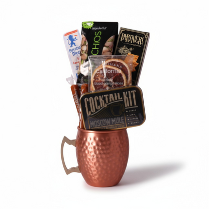 single Moscow mule mug gift basket includes a cocktail kit, two caramels, dried orange slices, crackers, pistachios and beef stick.