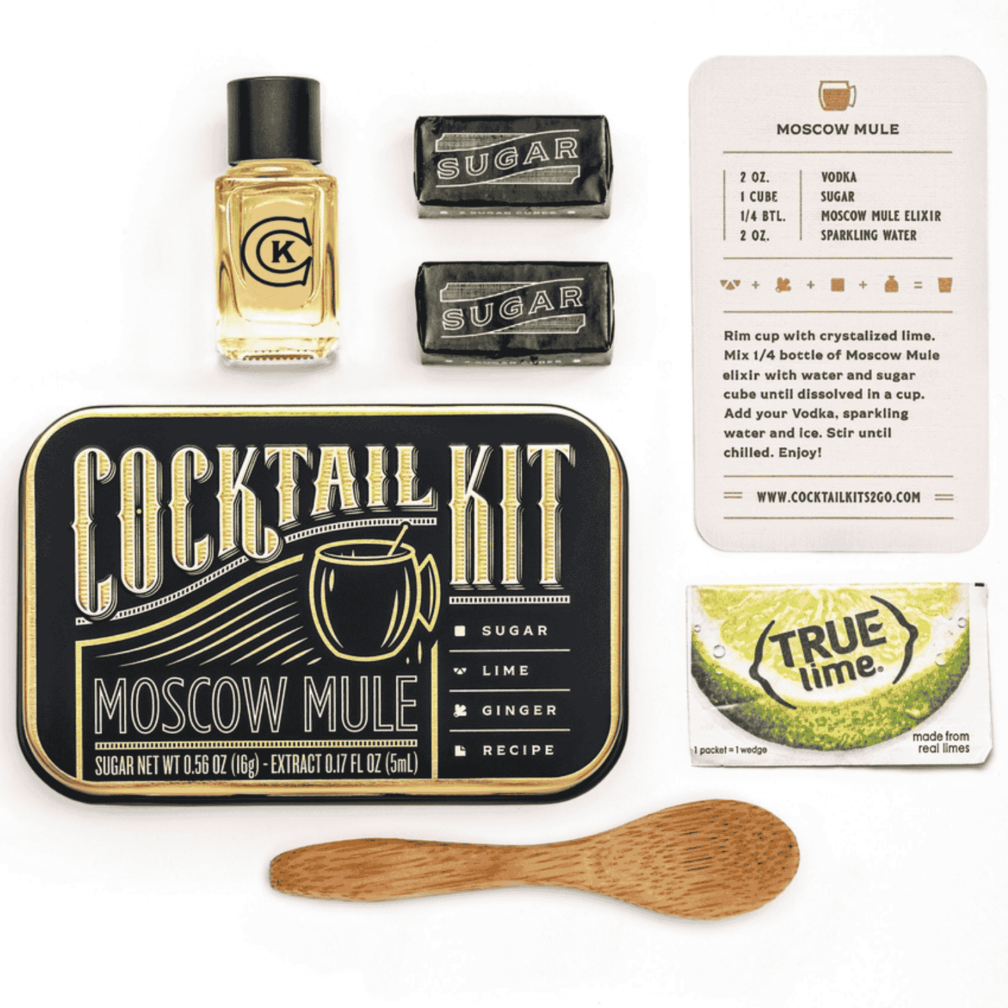 cocktail kit for a the Moscow Mule is a metal time with elixer, sugar cubes, lime recipe card and wooden mixing spoon inside.