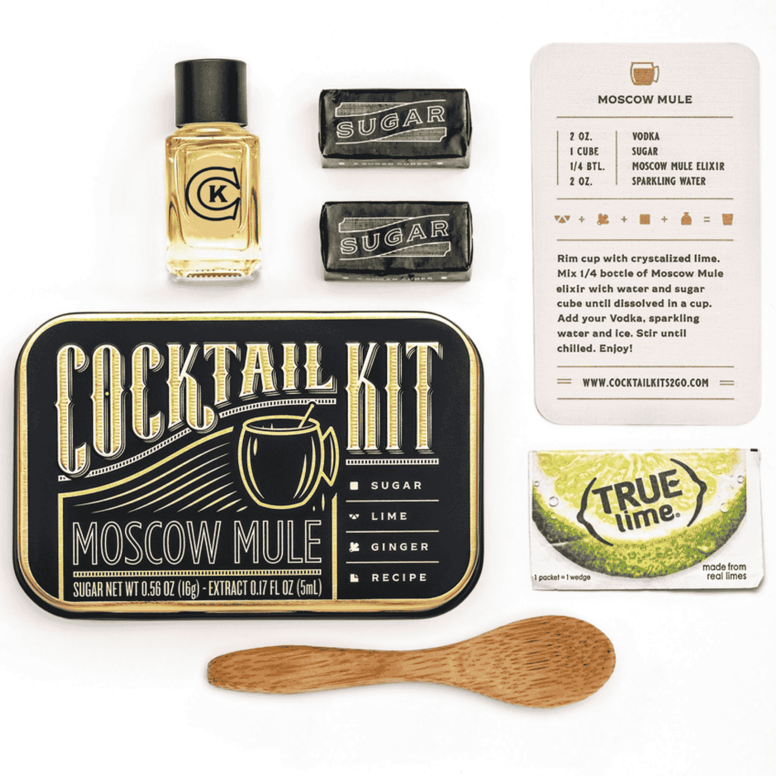 cocktail kit for a the Moscow Mule is a metal time with elixer, sugar cubes, lime recipe card and wooden mixing spoon inside.