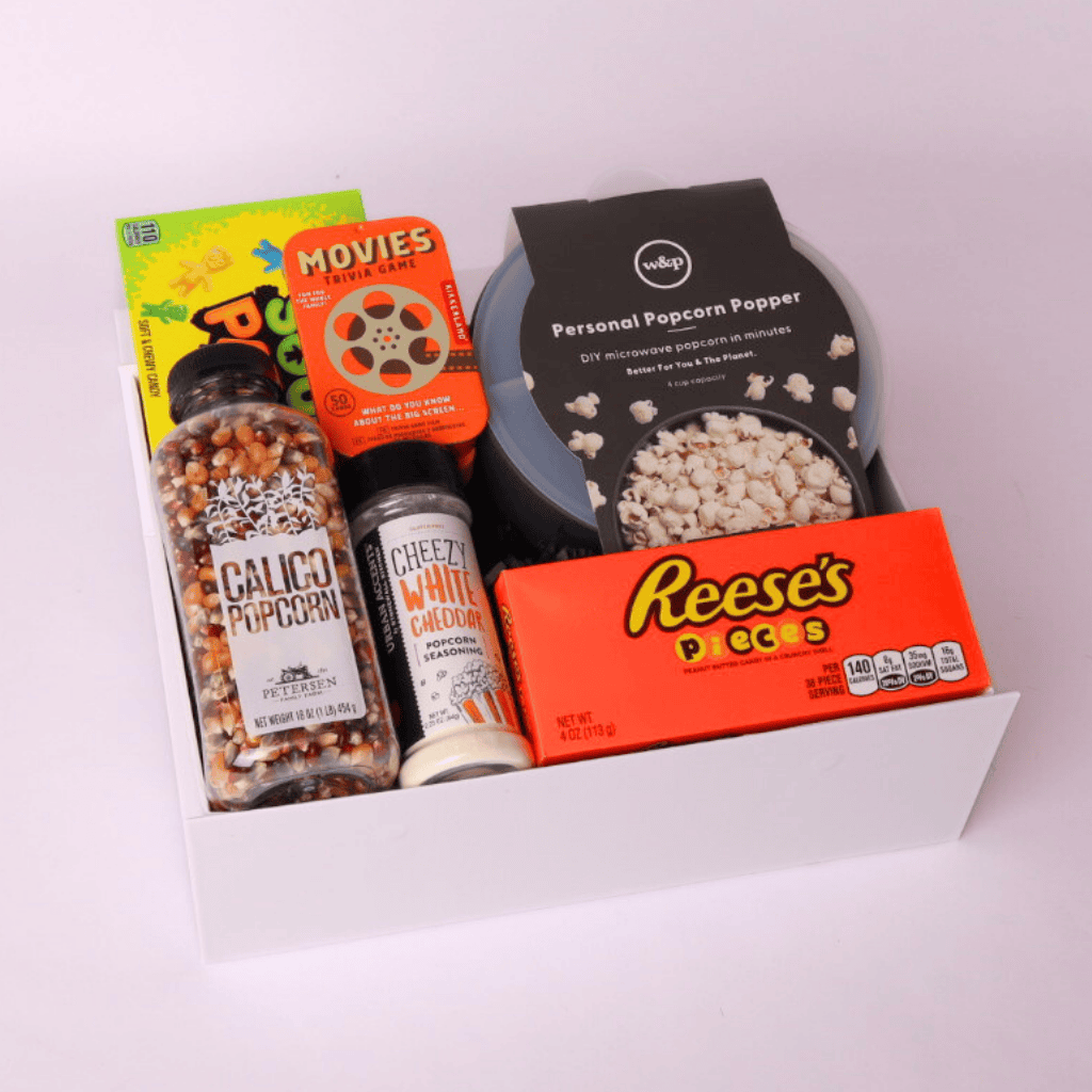 Gift box fully assembled with popcorn popper, movie snacks, trivia game, popcorn seasoning, and seed – perfect movie night gift for families or friends.