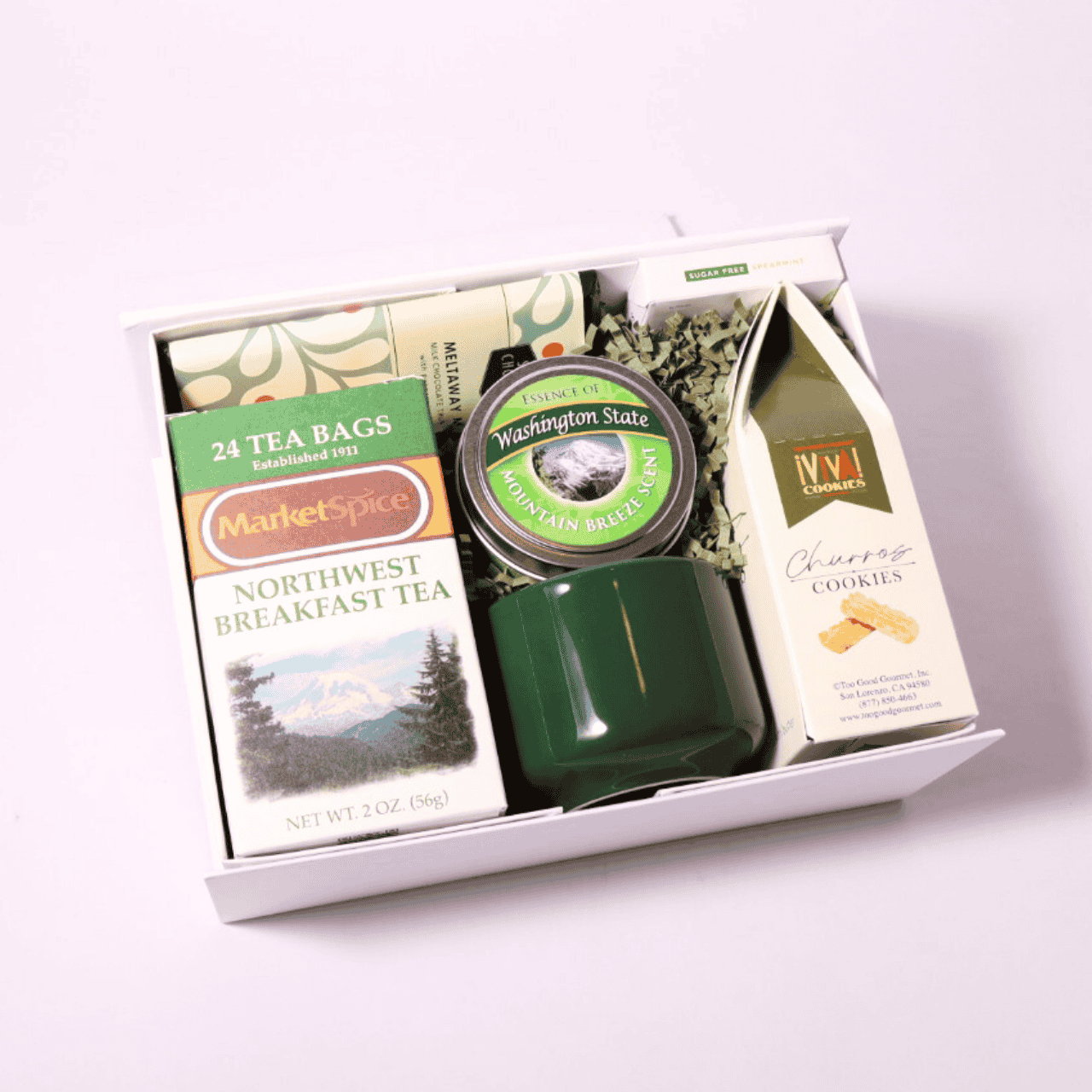 Tea lover’s gift box with a Pacific Northwest twist, featuring Washington-made treats: MarketSpice tea, a soy candle, mint chocolate, and a ceramic teacup. Perfect for birthdays, holidays, or self-care.