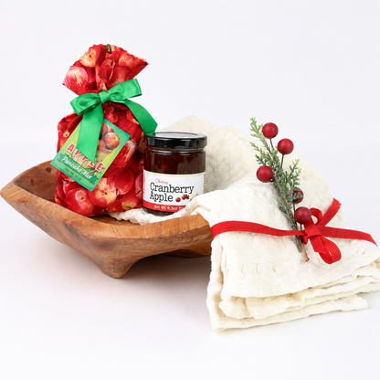 Northwest Christmas Morning holiday gift bowl wrapped with red ribbon featuring apple pancake mix, cranberry apple chutney and kitchen towel