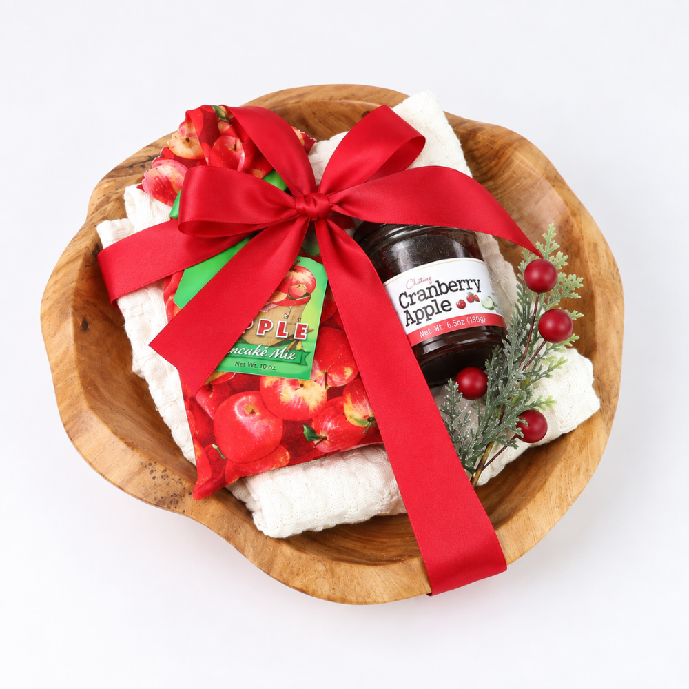 Top view of Northwest Christmas Morning gift bowl wrapped with a red satin ribbon in a reusable natural wood bowl