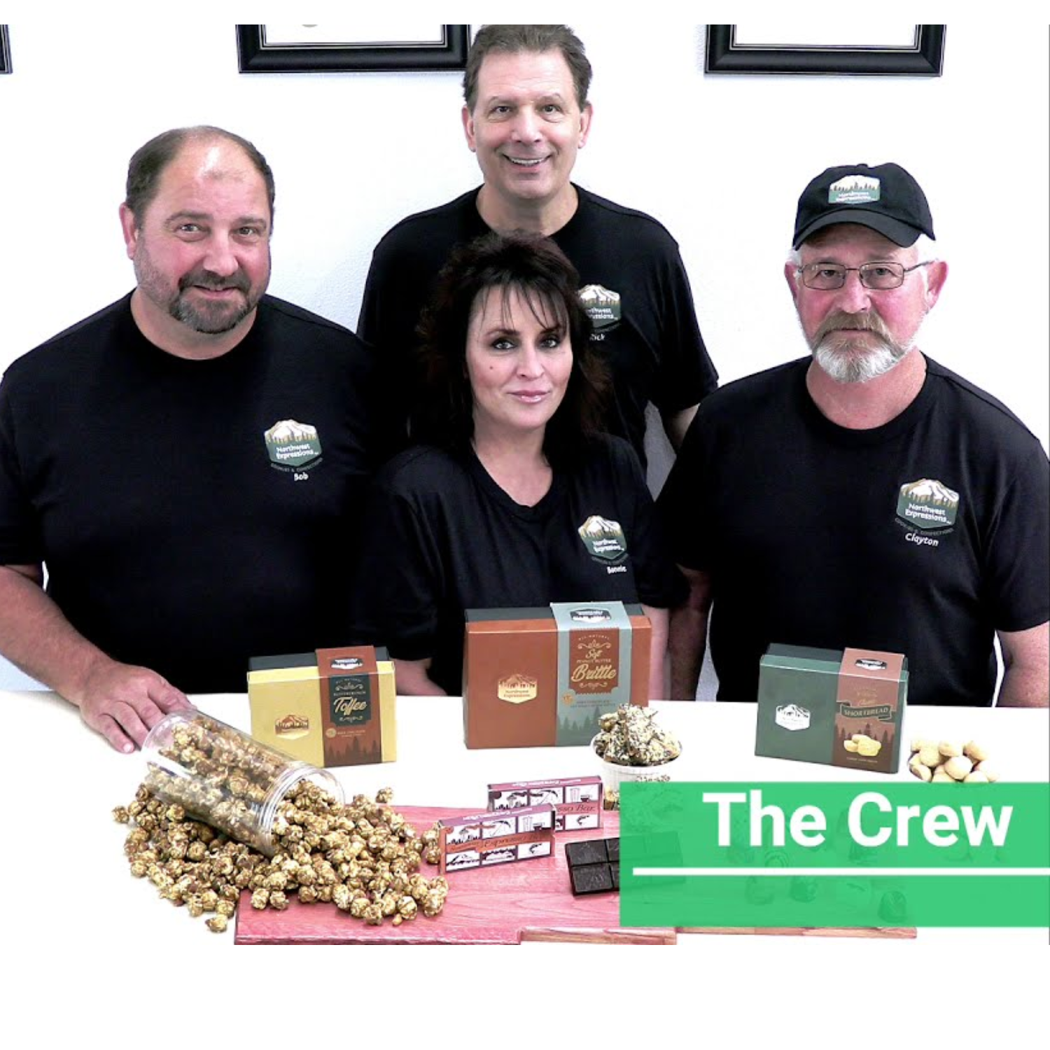 northwest expressions founders standing behind a table with popcorn and cookies.