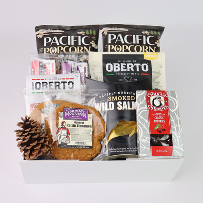 White gift box filled with pacific northwest snacks made in Washington including Pacific Popcorn, Oberto jerky, Cougar Mountain cookies, and smoked salmon