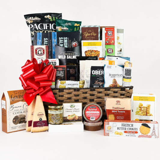 Large gourmet office gift basket filled with Pacific Northwest snacks, smoked salmon, popcorn, chocolates, crackers, cheese, cookies, nuts, and savory treats with a red bow.