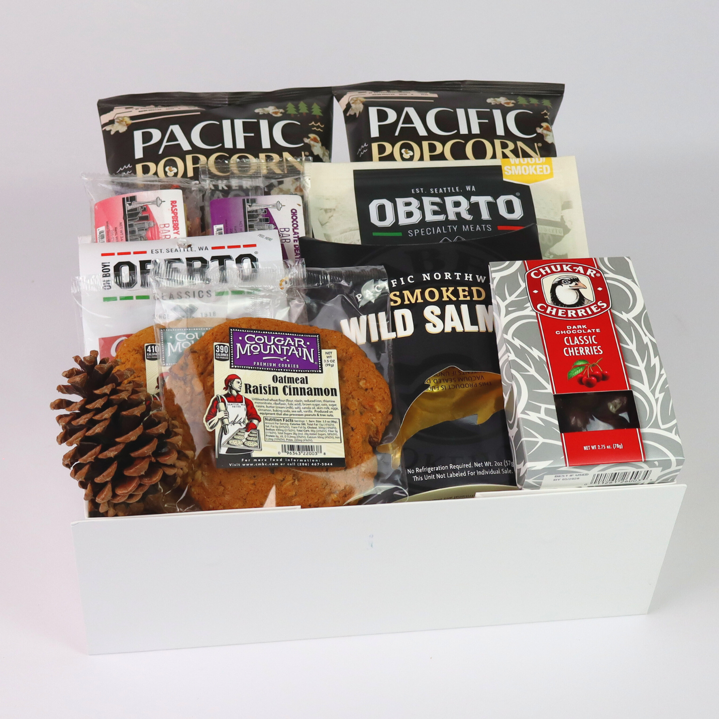 Close-up of Pacific Northwest gift basket featuring a curated selection of seattle's best chocolate bar, oberto jerky, cougar mountain cookies, chukar cherries and smoked salmon from the Pacific Northwest