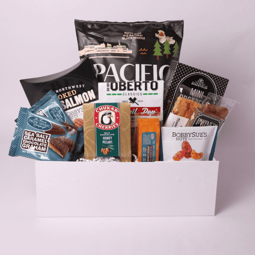 A beautifully curated snack gift box tied with a navy blue satin bow, featuring gourmet popcorn, nuts, pretzels, chocolates, and artisan treats. A perfect gift for clients, birthdays, or corporate gifting.