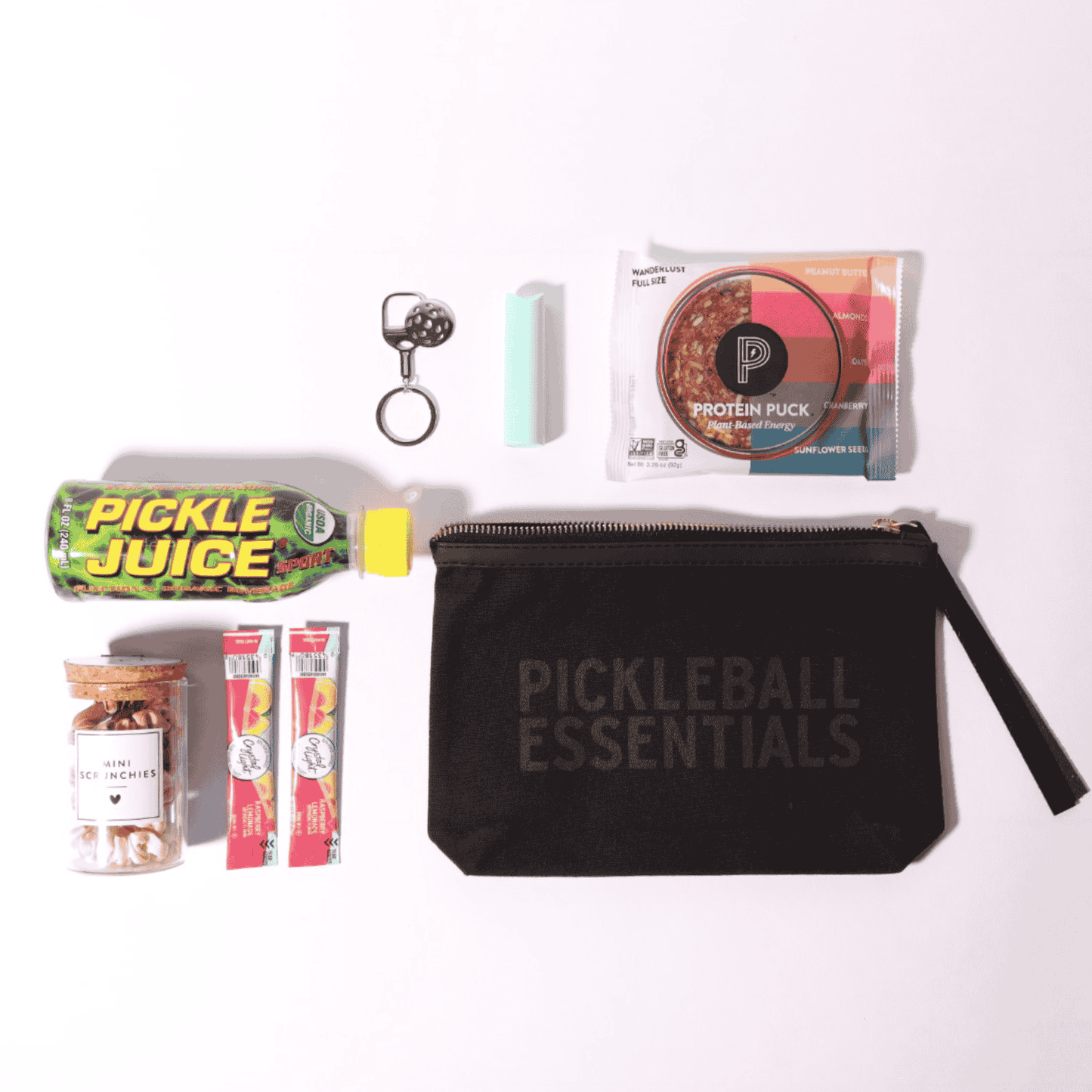 Celebrate the pickleball lover in your life with this thoughtful pickleball gift for her, including a convenient zipper pouch filled with essentials made in WA, such as drink mixers and scrunchies for on-the-go play.