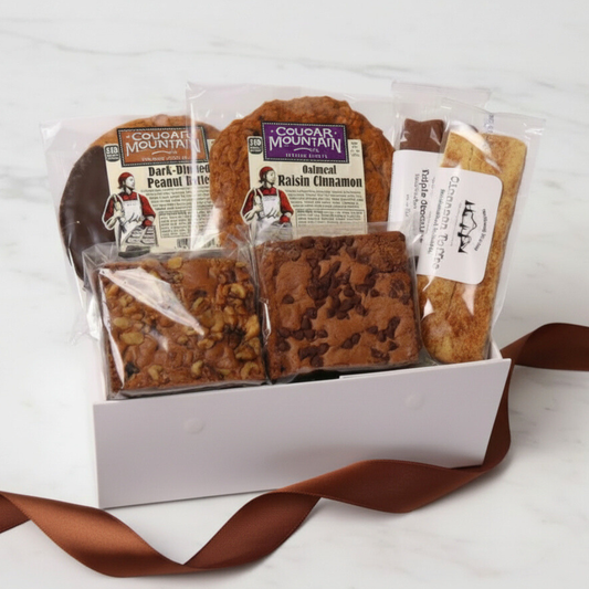 A delicious Pacific northwest Bakery gift Box featuring Northwest Biscotti, Cougar Mountain cookies, and Lydia’s Cakes & Confections brownies—perfect for a thank you gift, foodie gift, or corporate client treat.
